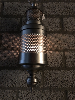 Hängelaterne aus grauem Metall, mit Perforation, um das Licht an die Wand zu leuchten
