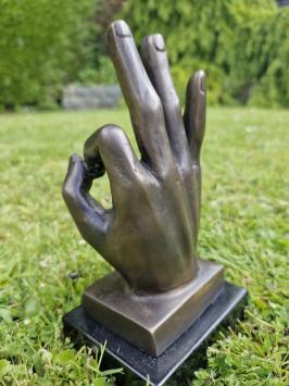 Bronzen beeld van hand met  'OK' handgebaar.